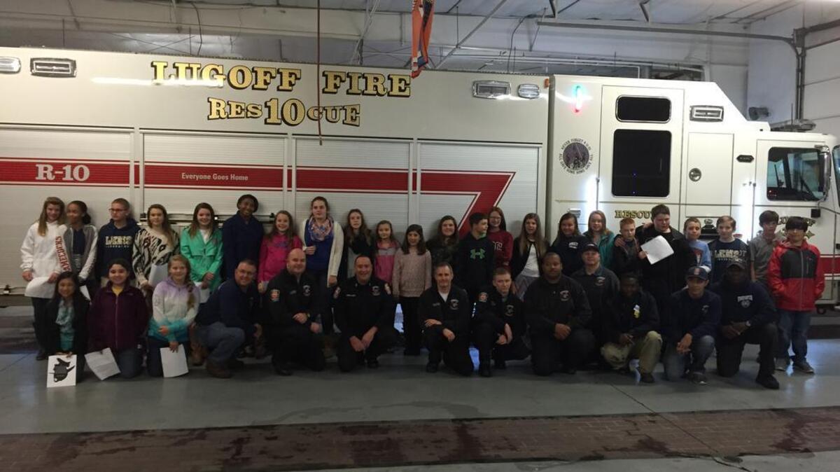 Members of the Lugoff-Elgin Middle School Beta Club pose with Lugoff firefighters after dropping off a meal and poster of the “Firefighter’s Prayer” Monday night.