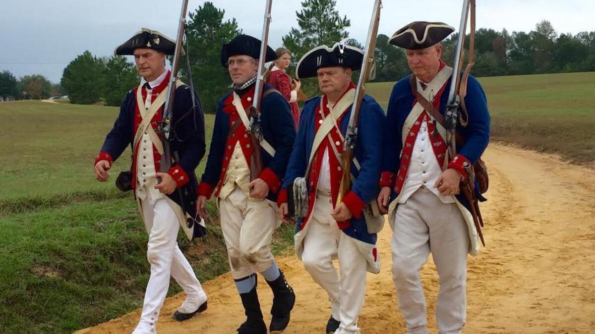 Continental Army, or American soldiers, reenactors march back to their camp after a skirmish with the Redcoats at Historic Camden’s annual Revolutionary War Field Days.