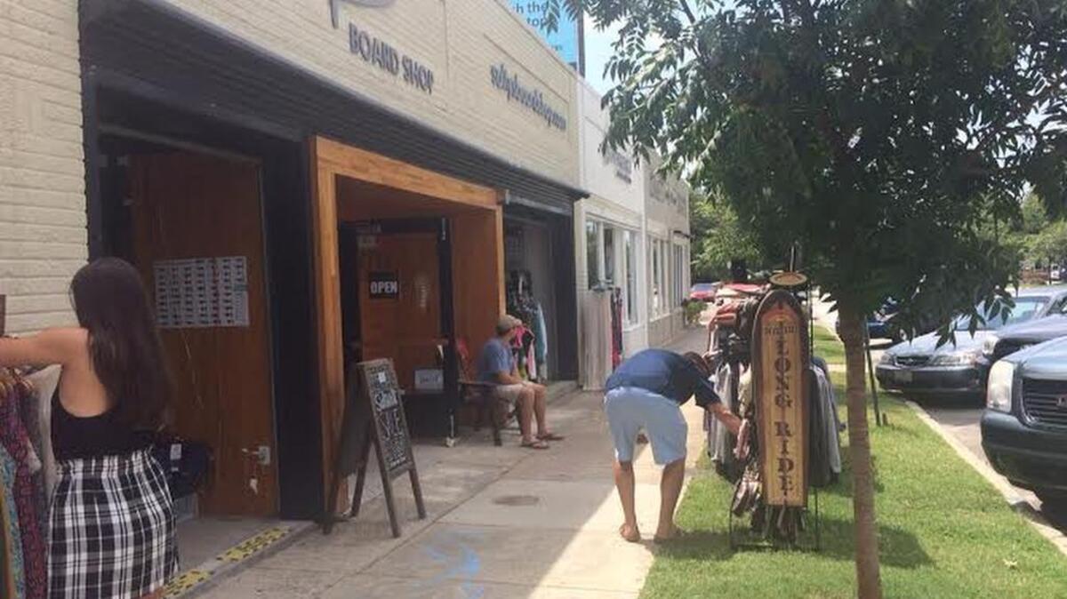 
Shoppers stop by the sidewalk sale at Salty’s Board Shop during South Carolina’s sales-tax-free-weekend on Sunday.
