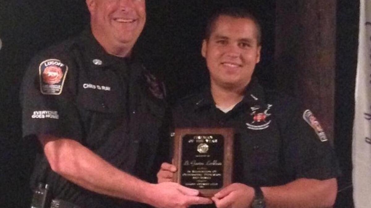 
Lugoff Fire-Rescue Chief Dennis Ray presents Lt. Gavine Locklear with the award for 2015 Optimist Club Firefighter of the Year.
