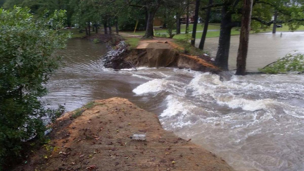 The upper level of the pond in the Shadblow neighborhood in Springdale is empty after a dam in the middle ruptured Saturday during a storm brought in by Hurricane Matthew, town officials say.