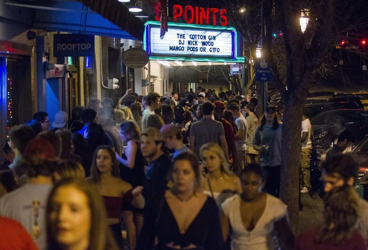 A large crowd blocks the sidewalk on Harden Street as they wait to enter Rooftop, Latitude 22 and the Cotton Gin. Thousands of people will make their way through Five Points to various bars in one night.
