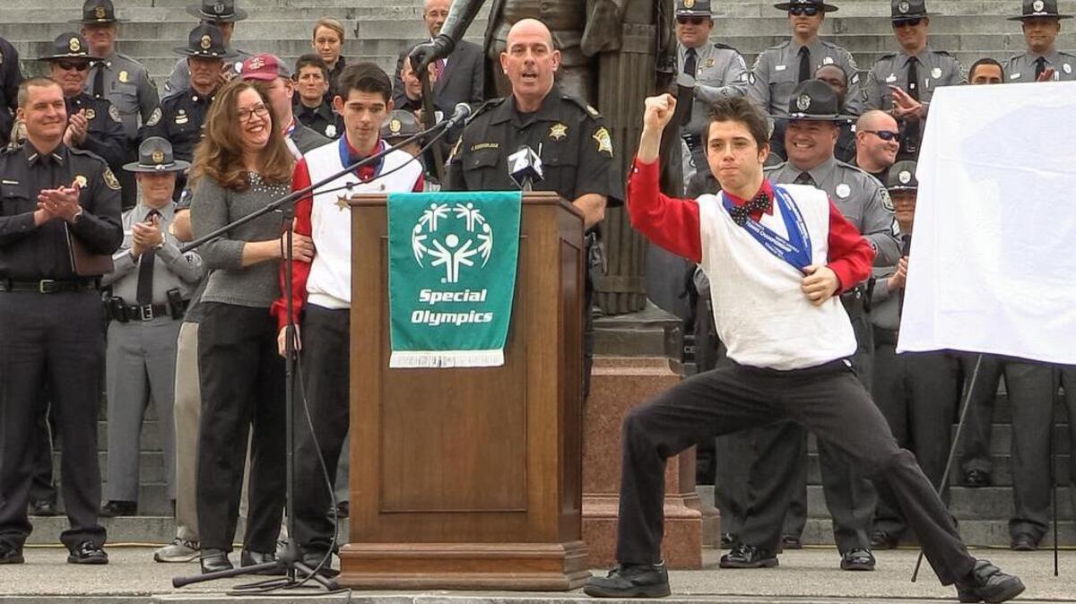 Special Olympics gold medalist Jackson Doudoukjian strikes a champion pose after his father, Richland County Sheriff's Deputy John Doudoukjian, Jr., mother Katherine and brother John III praised the the organization for giving their family a “sports home.”