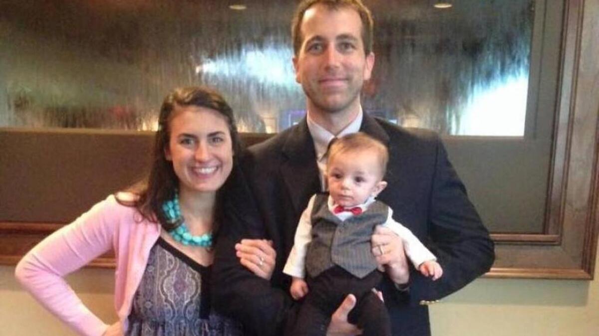 
Greg Alia stands next to his wife Kassy while holding their newborn son Sal.
