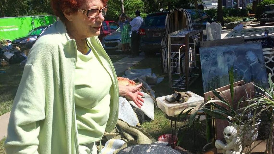 
Cydney Berry surveys her possessions, many of them badly water damaged, laid out Tuesday in the front lawn of her flooded Forest Acres condo. A group of off-duty soldiers from Fort Jackson had been voluntarily helping the condo residents recover their possessions Monday and Tuesday.

