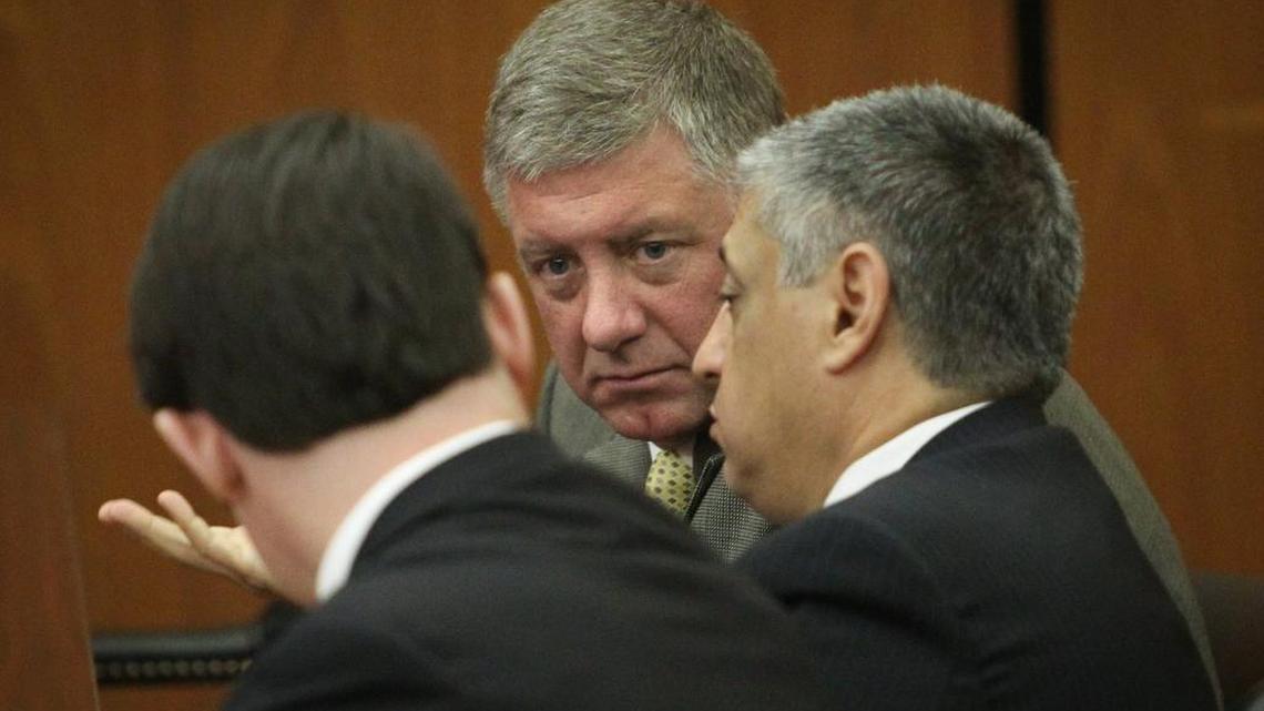 Suspended Rep. Jim Merrill, R-Berkeley, talks with his attorneys Matthew Hubbell and Leon Stavrinakis before his bond hearing in December before Judge Knox McMahon in the Richland County courthouse. Merrill faces a 30-count indictment in a special prosecutor probe into corruption at the State House.