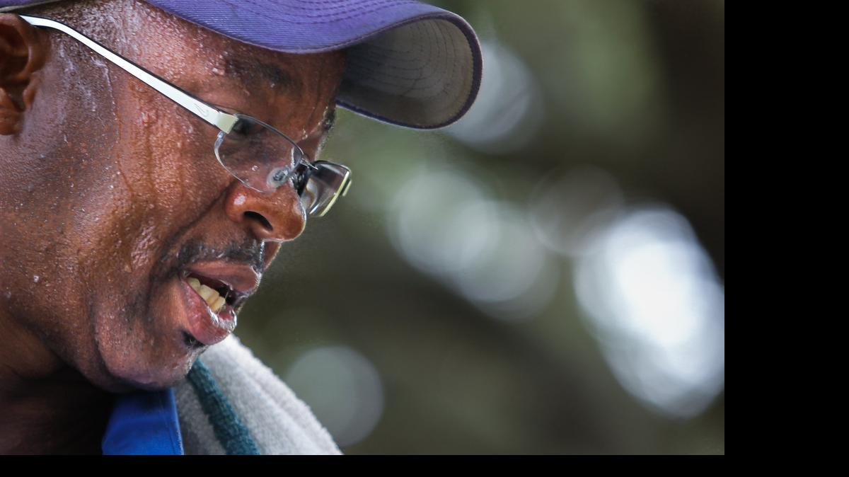Horticultural assistant Kip Small works up a sweat while tending to the gardens on Columbia College campus. "I love it out here," Small said, not phased by the heat. 7/29/15
