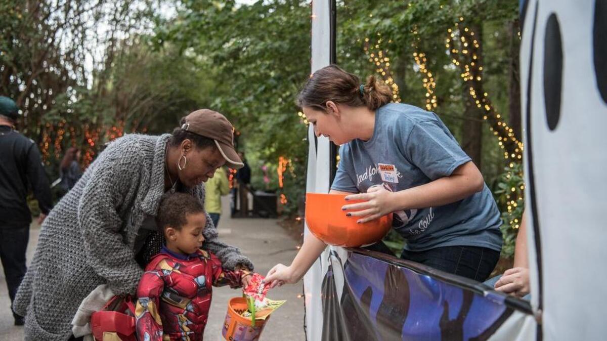 Felicia Rush assists Aston Rush as he trick or treats Boo at the Zoo volunteer Haley Searson during the Halloween event held at Riverbanks Zoo in 2016. The weather for trick or treating in Midlands this Halloween will be rain free and unusually warm.