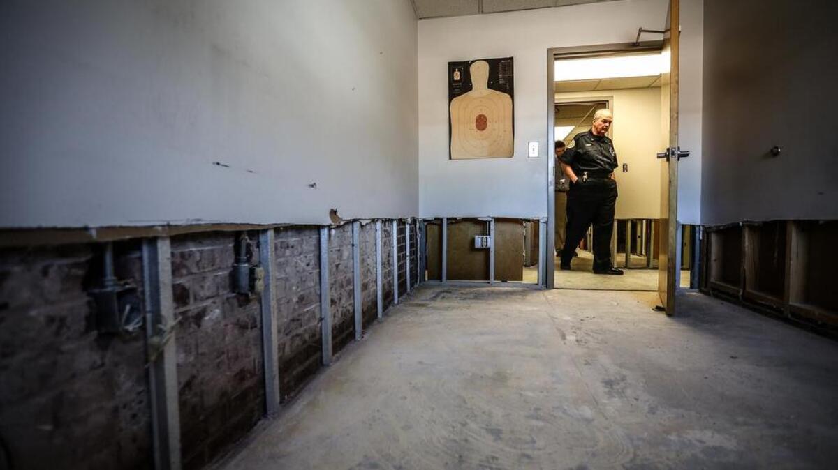 Forest Acres Police Chief Gene Sealy walks through the gutted police station.