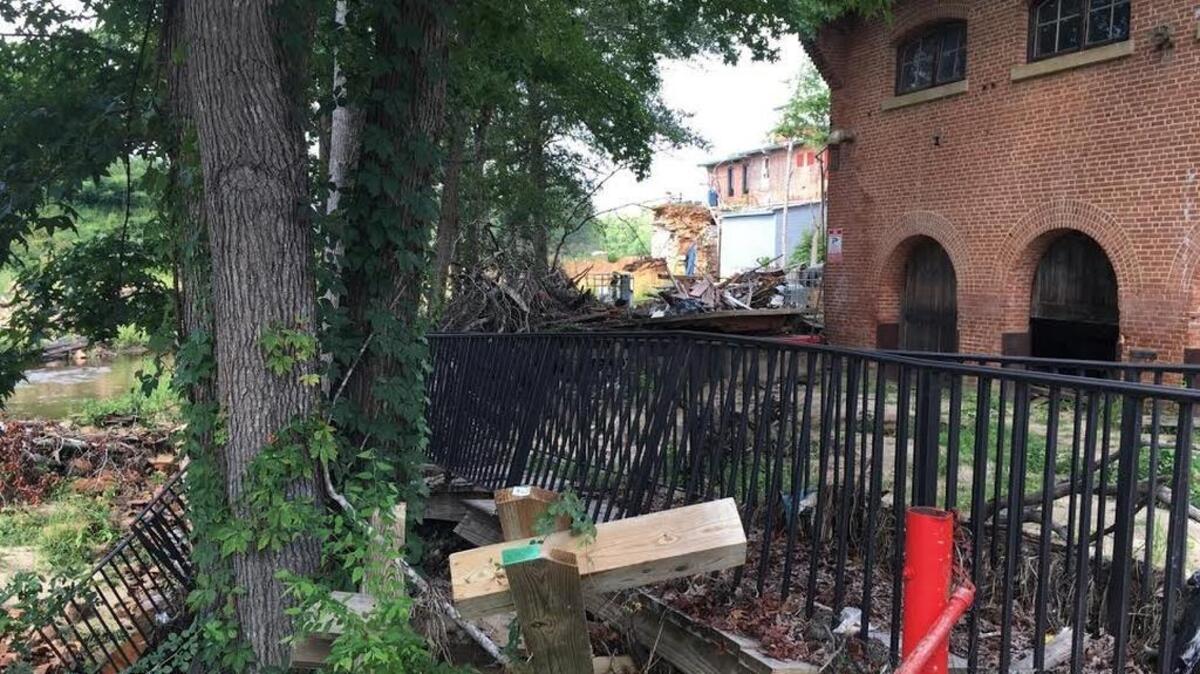 Debris from last fall’s flood still rests near the Old Mill shopping center in downtown Lexington.