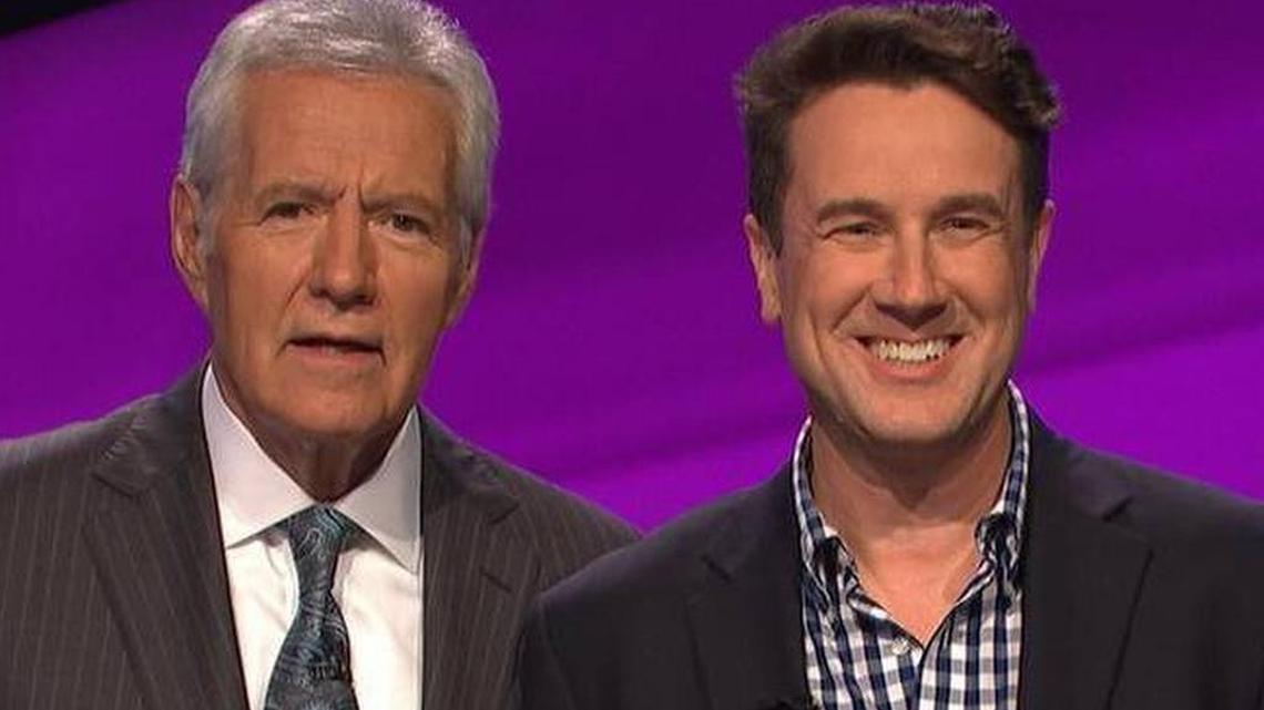 Robert Barron, a teacher from Columbia on the right, is pictured with Jeopardy host Alex Trebek.