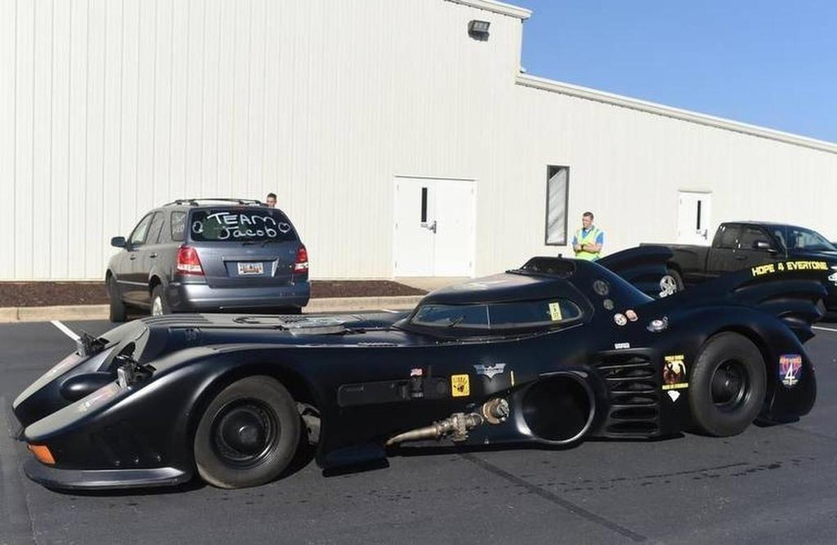A Batmobile arrives before a superhero-themed funeral service for Jacob Hall, a 6-year-old boy who was killed in a school shooting.