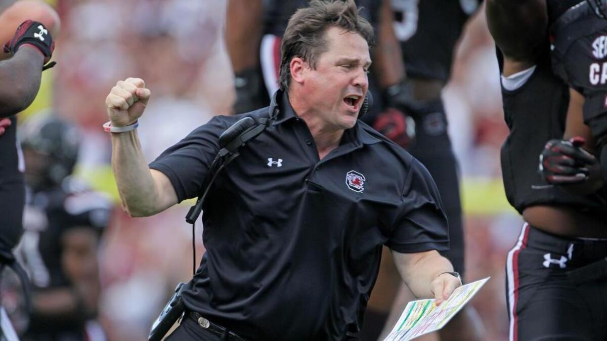 USC coach Will Muschamp celebrates a fumble recovery.