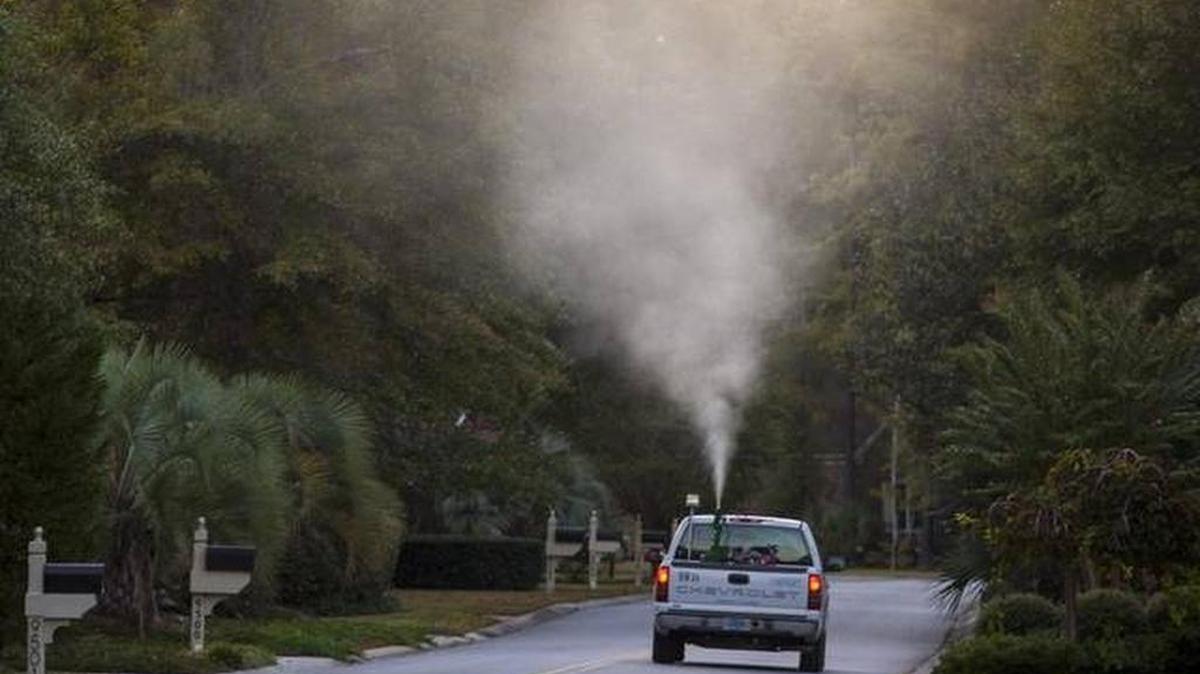 A mosquito spraying truck runs through an Horry County neighborhood in October.