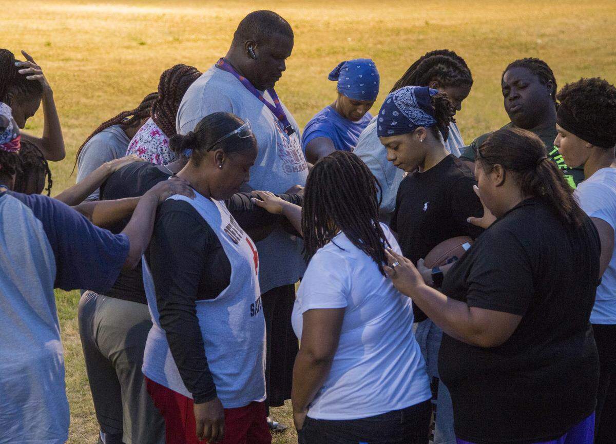 S.C. Smash owner and coach Lamar Ray stands in the center of a huddle as the teams prays at the end of practice in Columbia, SC. Ray has been coaching football most of his life but this is his first season with the team.