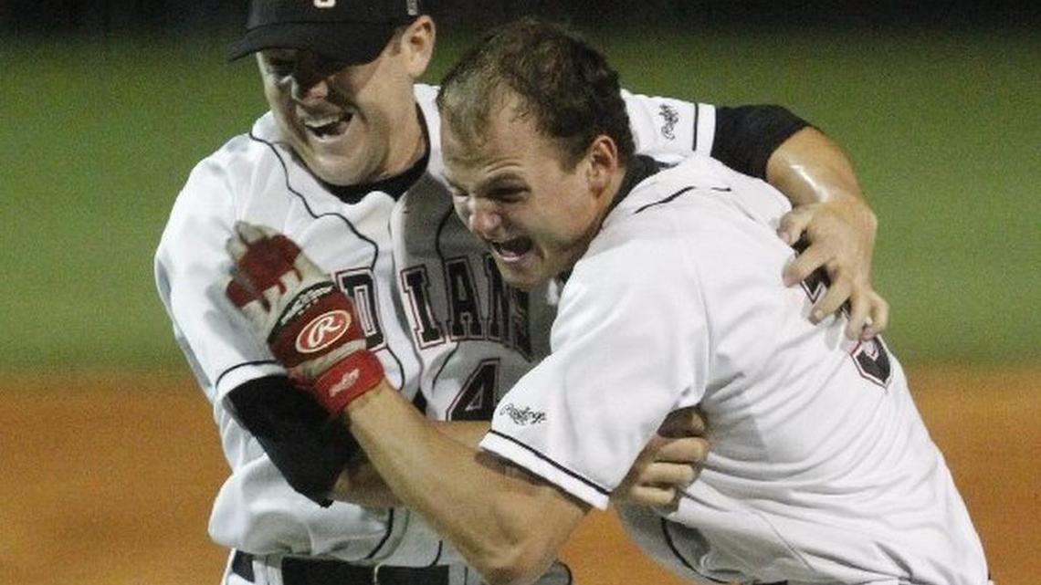 FILE PHOTO: In May 2012: Gilbert High School pitcher Mike Morrison, right, embraces Conner Owings, who pitched a strikeout to clinch the 2A State Championship baseball series. Both men are now members of the CWS champion Coastal Carolina Chanticleers.