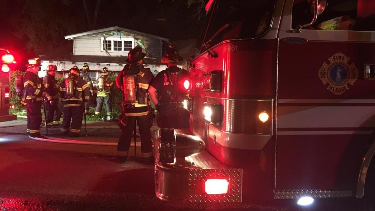 Firefighters work to put out a fire at a residence at 1108 Queen St. early Thursday morning.