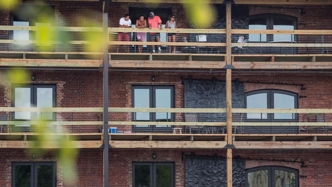 College students take in a porch view from their new residence at The Apartments at Palmetto Compress in Columbia, SC. The warehouse building has been on the National Register of Historic Places since 1985.