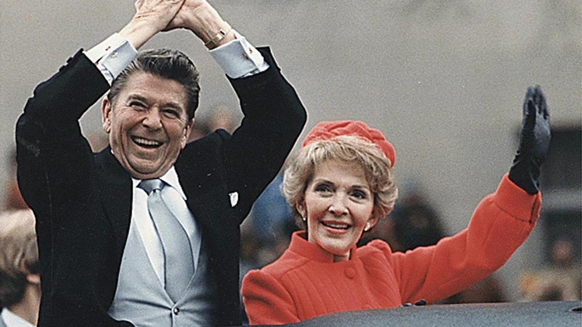 President Ronald Reagan and First Lady Nancy Reagan wave the 1981 Inaugural Parade.