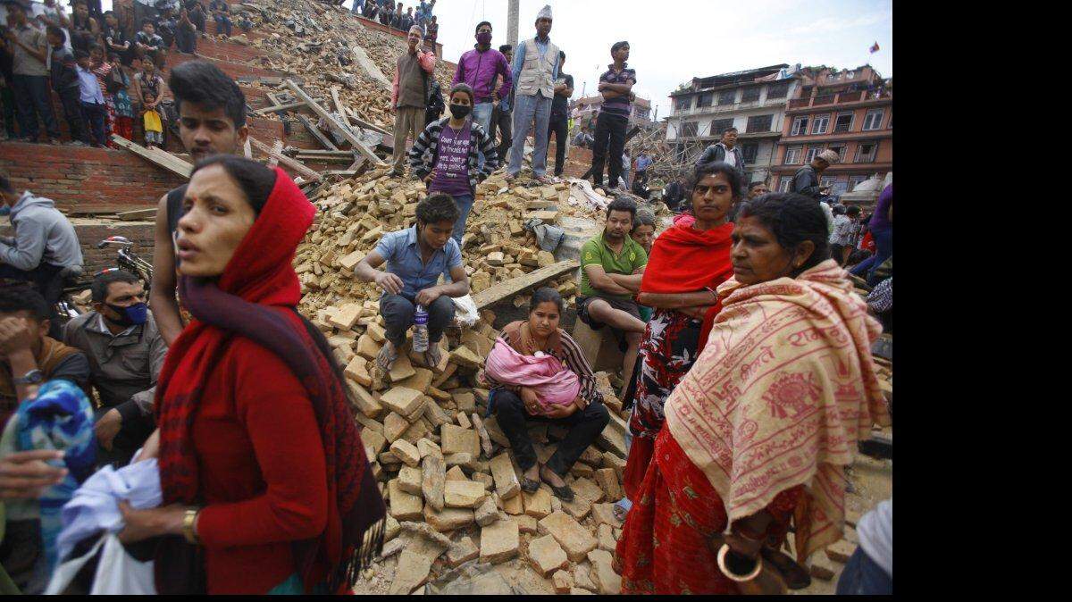 
People rest on debris at Durbar Square after an earthquake in Kathmandu, Nepal, on Saturday. 
