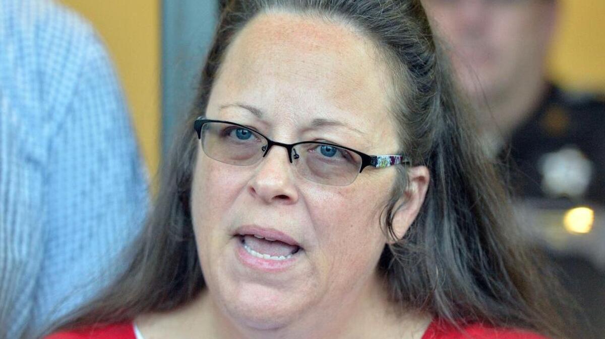 
Rowan County Clerk Kim Davis makes a statement to the media at the front door of the Rowan County Judicial Center in Morehead, Ky., Monday, Sept. 14, 2015. Davis announced that her office will issue marriage licenses under order of a federal judge, but will not have her name or office listed. (AP Photo/Timothy D. Easley)
