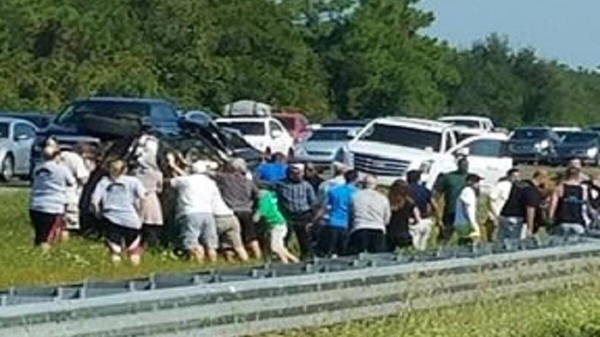 Dozens of strangers came together Saturday morning to help after a crash on I-75. They were able to get the 31-year-old driver and one of the young passengers out.