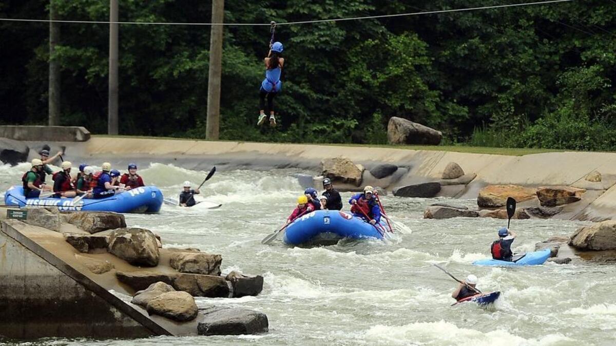 Rafters , kayakers, and hipline riders make their way through their courses at the U.S. National Whitewater Center.