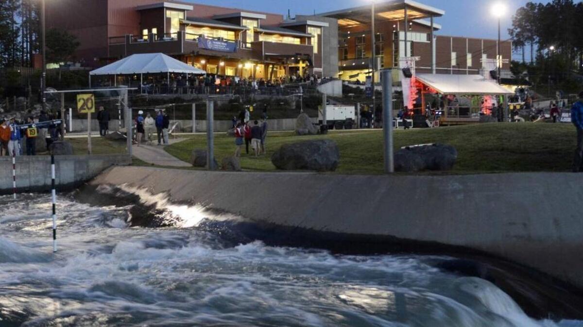 The U.S. National Whitewater Center at dusk. The center operates a variety of recreational facilities, including an artificial river, zip lines, rock climbing, mountain biking and trails. It has also been host site for the Canoe Slalom Olympic Trials and other competitions.