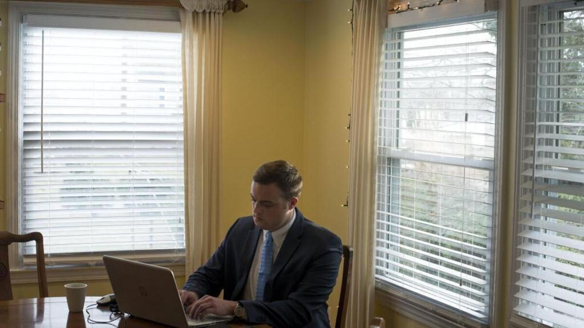 Cameron Harris works in his home office in Annapolis, Md., on Monday. Harris created a fake story about an electrical worker who stumbled upon stacked boxes of ballots marked for Hillary Clinton. It was eventually shared with 6 million people.