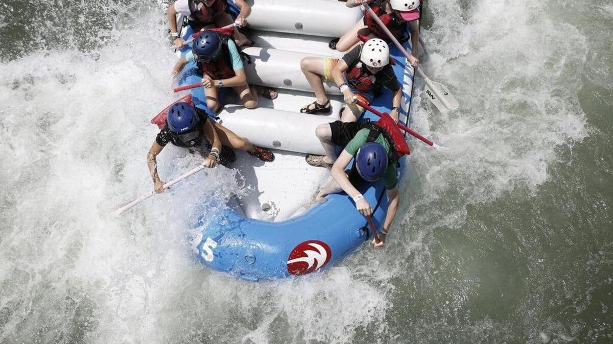Rafters paddle down the manmade river at the U.S. National Whitewater Center.