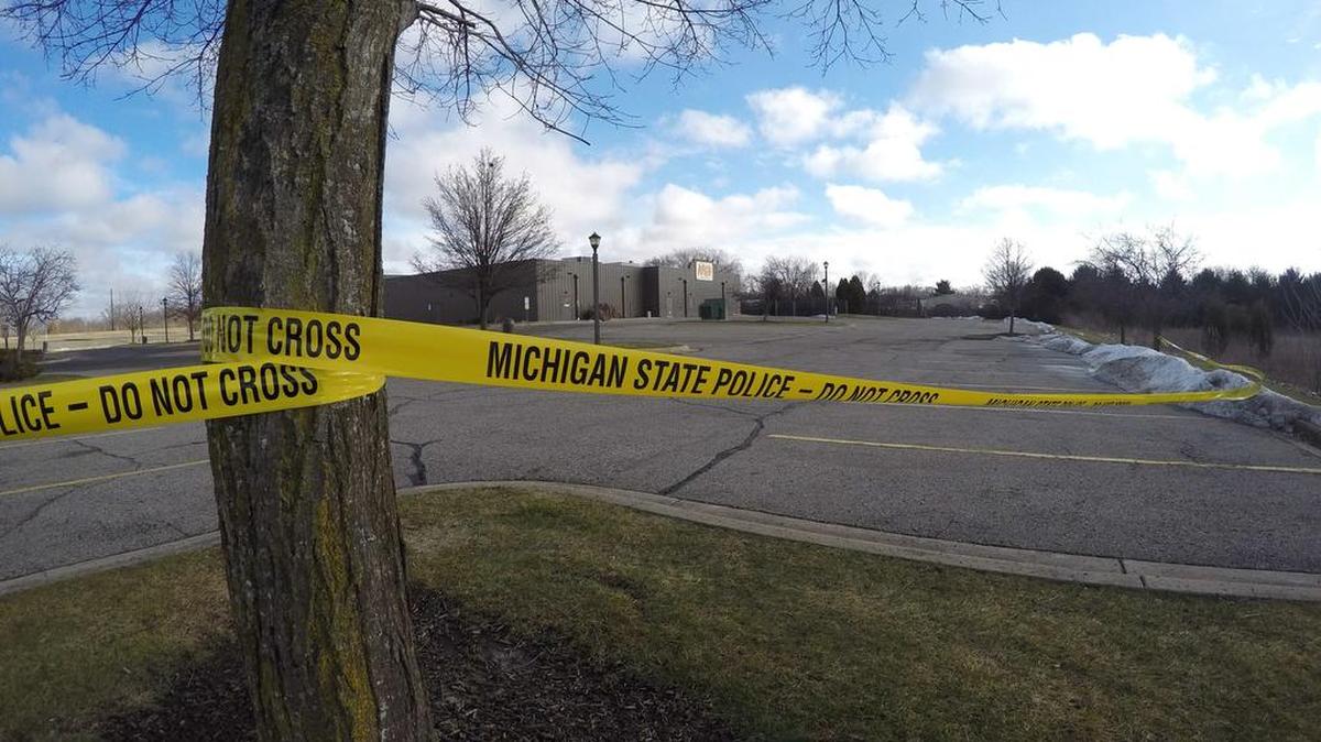 Police tape surrounds the area of a random shooting on Sunday, Feb. 21, 2016, in Kalamazoo, Mich. Jason Dalton of Kalamazoo County was arrested early Sunday in downtown Kalamazoo following a massive manhunt after several victims were shot at random.