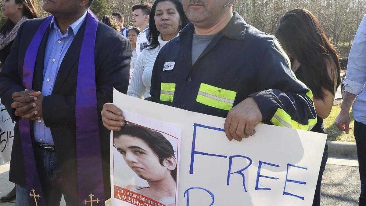 Moises Salmeron with a picture of his nephew Pedro Arturo Salmeron 18, during a prayer protest at the Department of Homeland Security to plead for his release on Feb. 29, 2016.