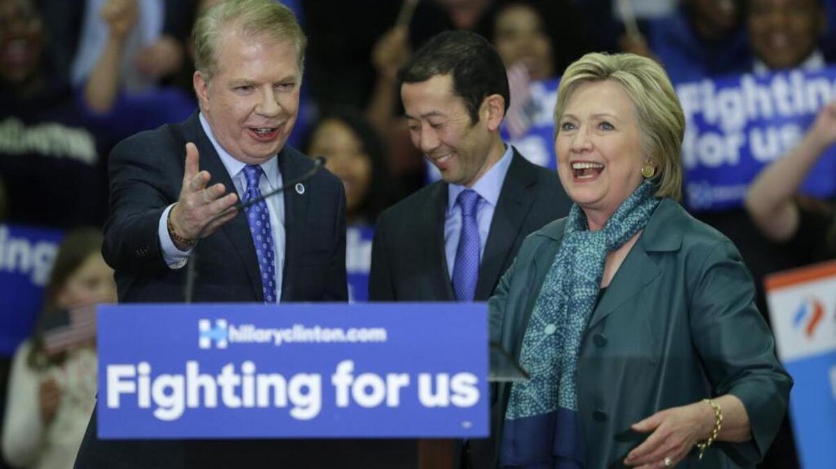Democratic presidential candidate Hillary Clinton, right, is introduced by Seattle Mayor Ed Murray, left, Tuesday, March 22, 2016, during a campaign rally at Rainier Beach High School in Seattle.