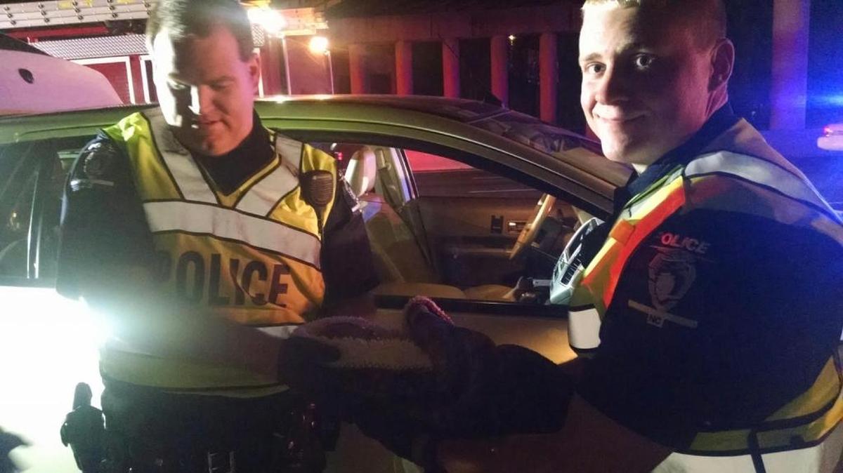 Charlotte-Mecklenburg police Officers Michael Caskey, left, and Kevin Jackson were investigating a fatal wreck early Saturday when they were alerted to a woman giving birth in a car that was stuck in the resulting traffic. The officers helped deliver a healthy baby girl.
