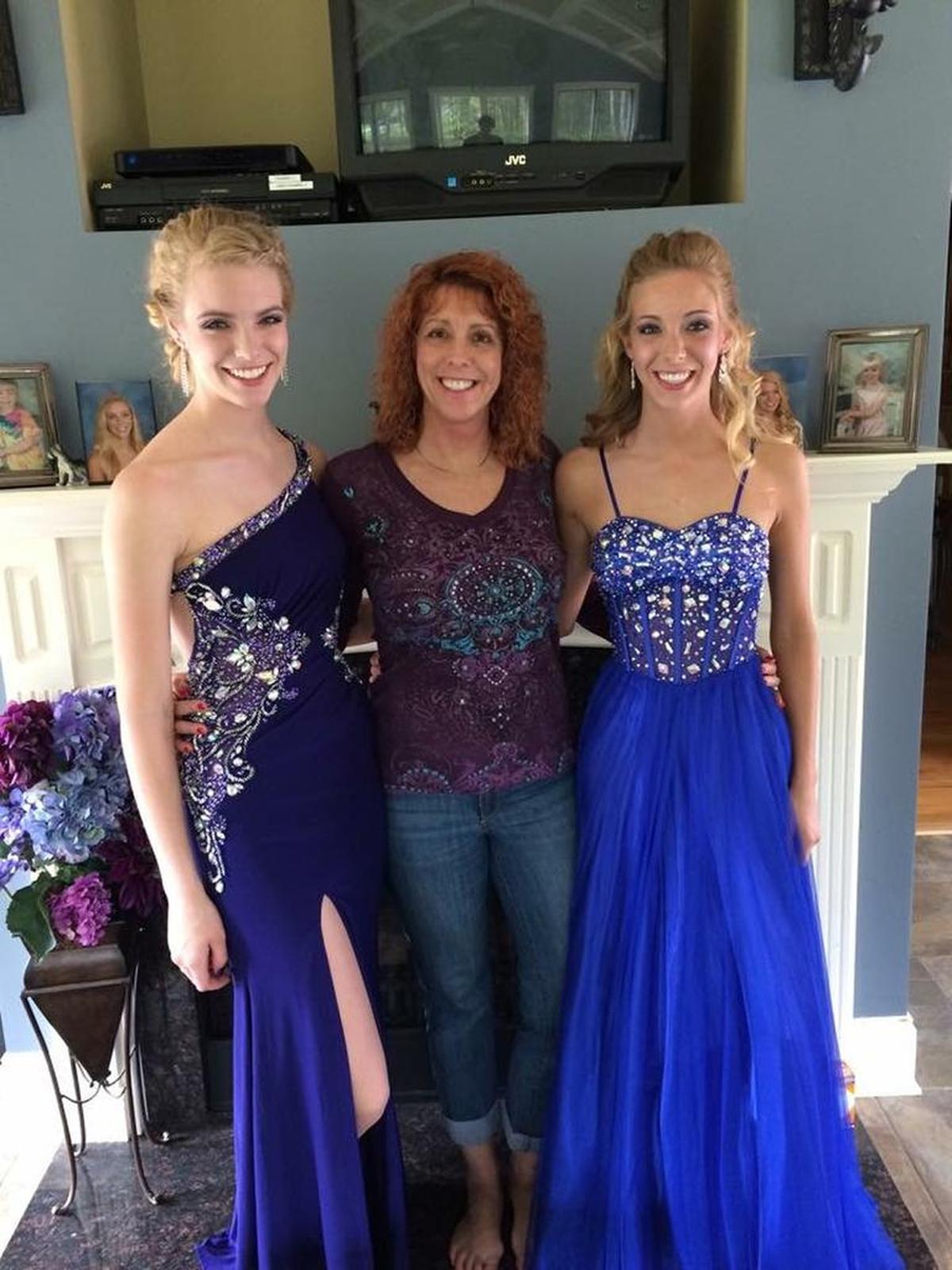 Kelsey Richardson, left, and Karli Richardson, right, with their mother, Cathy Hocking, in an old prom photo.