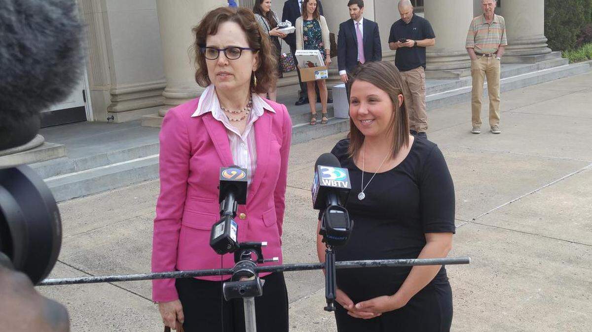 Former fire investigator Crystal Eschert, right, and her attorney, Meg Maloney, speak to reporters Thursday after a jury awarded Eschert $1.5 million in her lawsuit against the city.