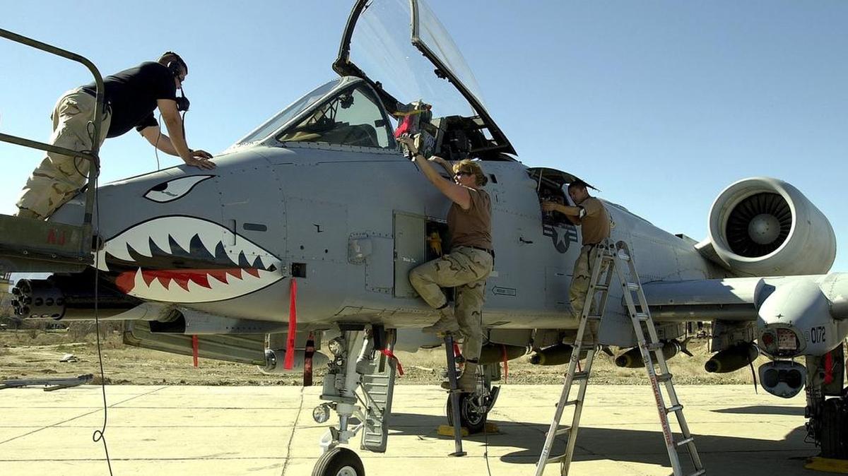 Tech. Sgt. Lisa Craven, of Pittsburgh, Pennsylvania, right, works on an AC-10 Warthog with Staff Sgt. Jim Adams off Melville, New York, at Bagram Air Base Monday, March 25, 2002, in Afghanistan.