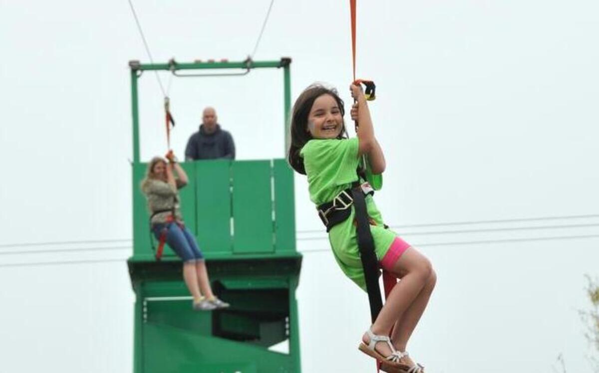
(FILE PHOTO :April 2013) Lizzie Campbell, 5, right, and Josie Jones, 13, ride down the zipline at the Sparkleberry Country Fair.
