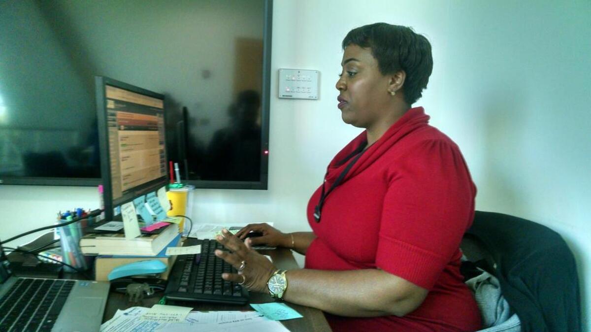 Community health specialist Sharita Moultrie prepares to meet with a customer for the federal health care market place in her office at the Richland Library last month.