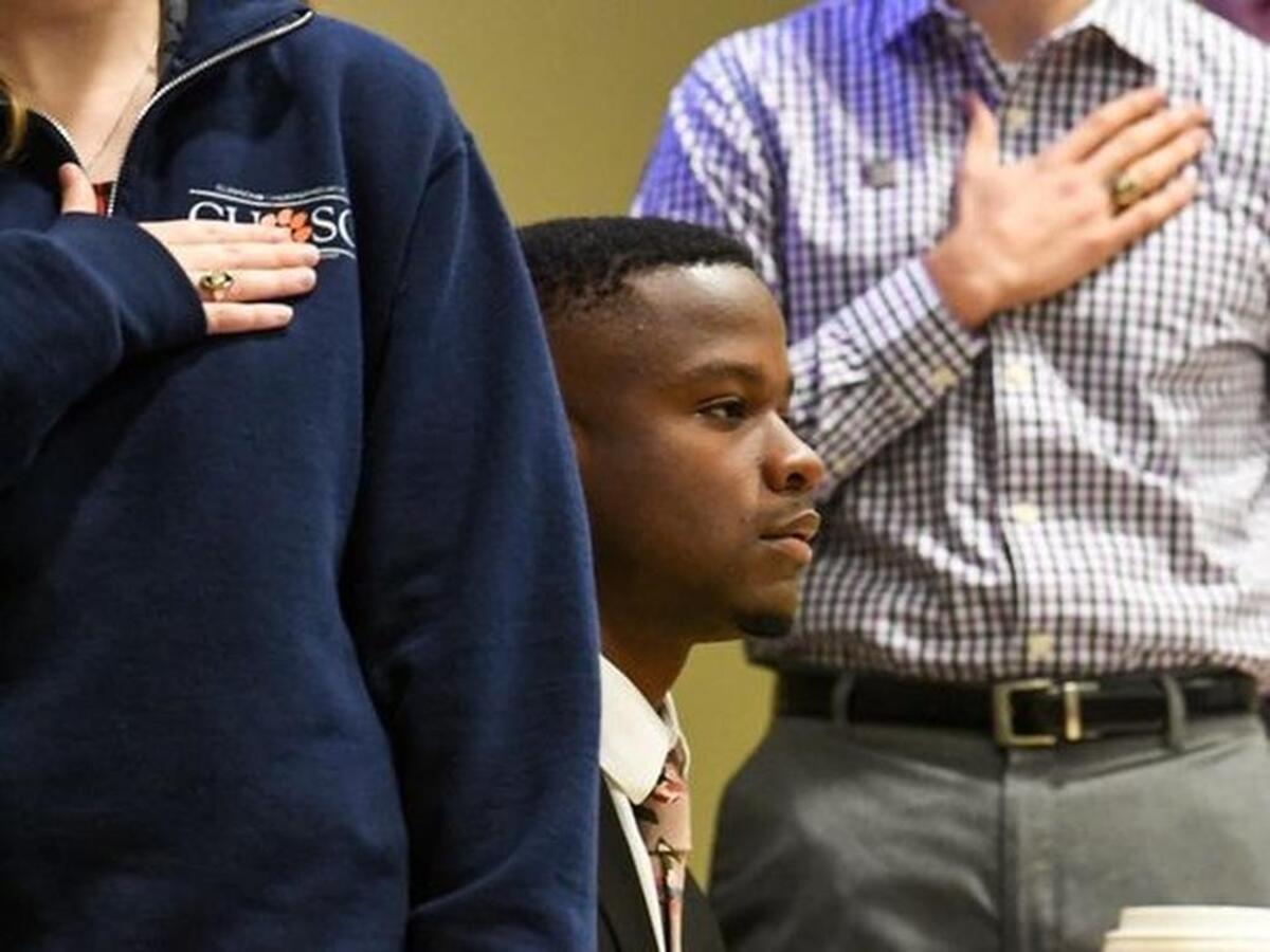 Vice President Jaren Stewart, sits between Secretary Kara Donovan, left, President Leland Dunwoodie, middle, for the Pledge of Allegiance during the Clemson Undergraduate Student Senate meeting in the Student Union in Clemson on Monday.