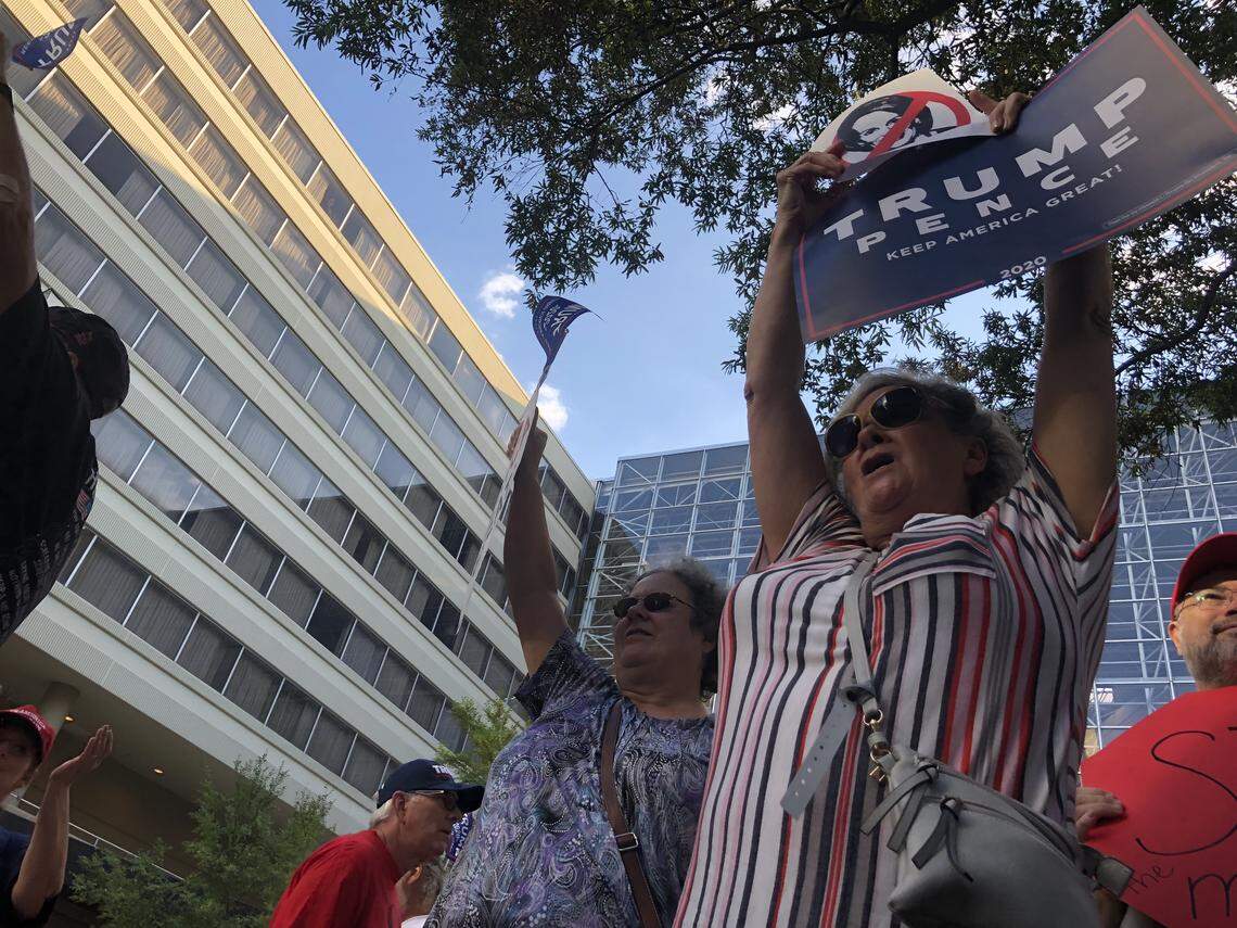 President Donald Trump supporters Lisa Murray, left, and Myrtle Cox of Taylors, S.C., protest outside the Hyatt Regency, where U.S. House Speaker Nancy Pelosi spoke at a S.C. Democratic Party fundraiser on Friday, Oct. 4, 2019,