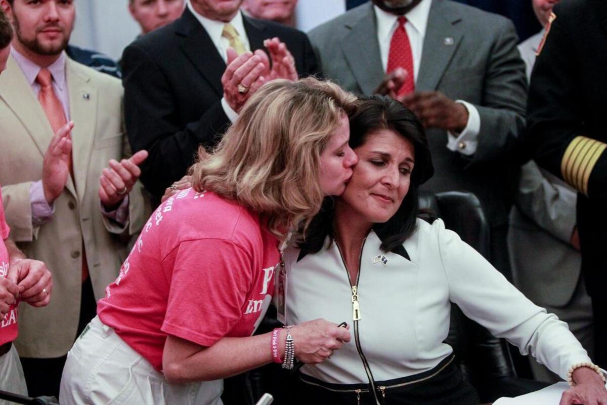 Karen Longstreet embraces S.C. Governor Nikki Haley during a ceremonial signing of Emma's Law. The law, requiring ignition interlock devices for some first-time DUI offenders, goes into effect on Oct. 1, 2014.