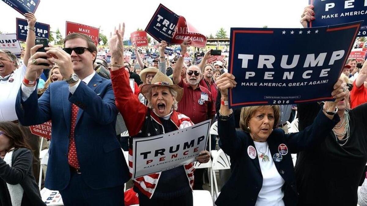 Supporters of Republican Presidential candidate Donald Trump give him a rousing ovation as he arrives on stage at White Oak Ampitheatre in Greensboro, N.C. Friday, Oct. 14, 2016.