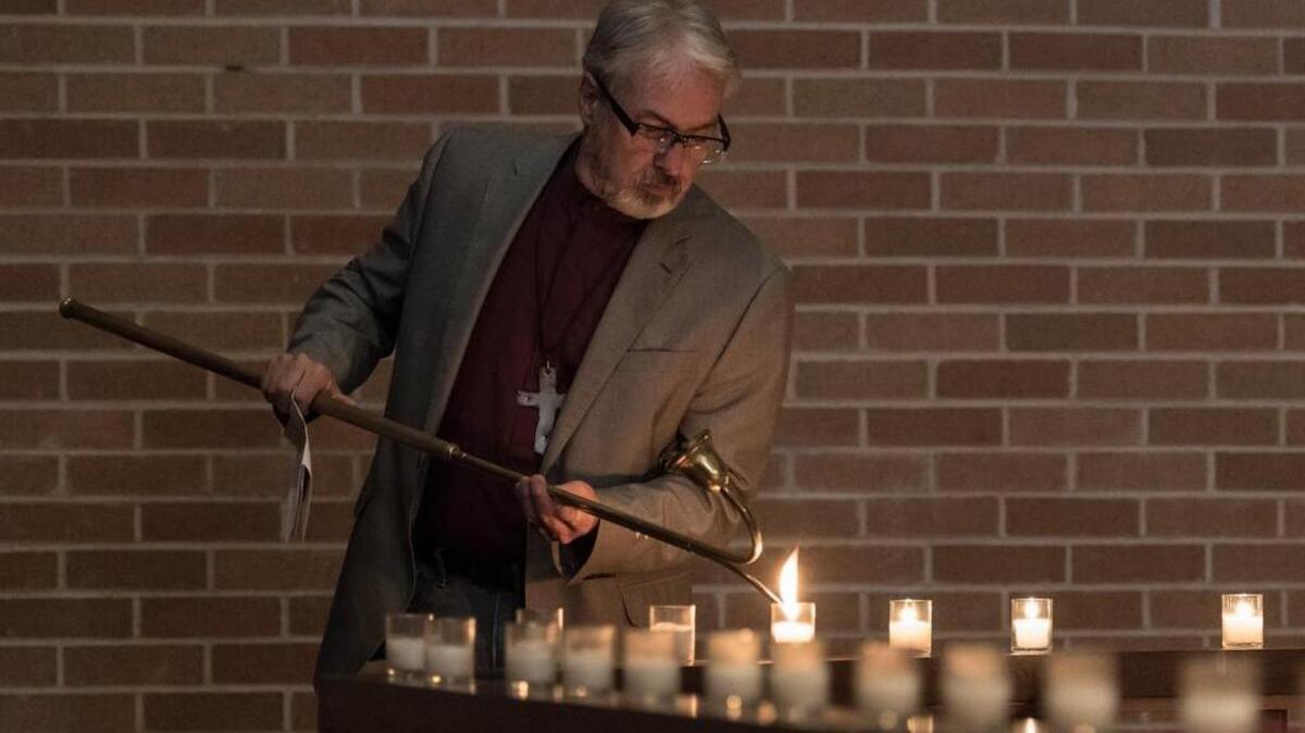 Reformation Lutheran Church pastor Tim Bupp lights candles in honor of the lives of the 59 concertgoers who lost their lives during the Las Vegas massacre.