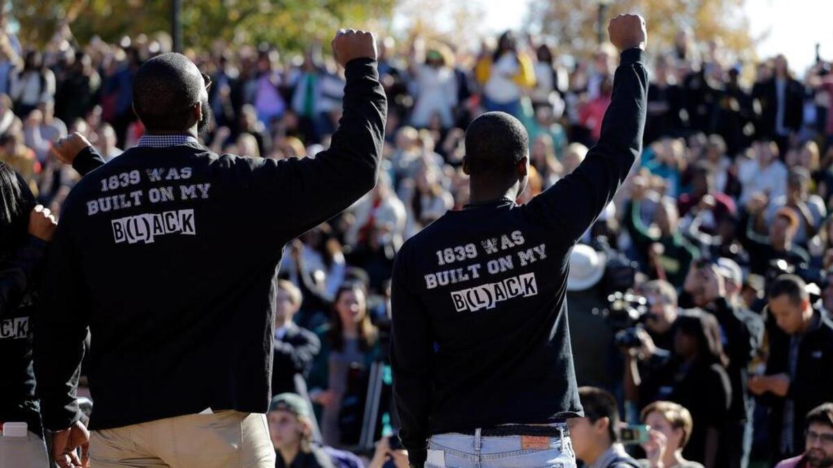 In this photo taken Nov. 9, 2015, members of the black student protest group, Concerned Student 1950, raise their arms while addressing a crowd following the announcement University of Missouri System President Tim Wolfe would resign, at the University of Missouri in Columbia, Mo. On the campaign trail, among candidates of both parties, the idea of locking up drug criminals for life is a lot less popular than it was a generation ago. The 2016 presidential race has accelerated an evolution away from the traditional tough-on-crime candidate. A Republican Party that’s long taken a law-and-order stance finds itself desperate to improve its standing among minority voters while Democratic candidates are also being drawn into national conversations on policing, drug crimes and prison costs.