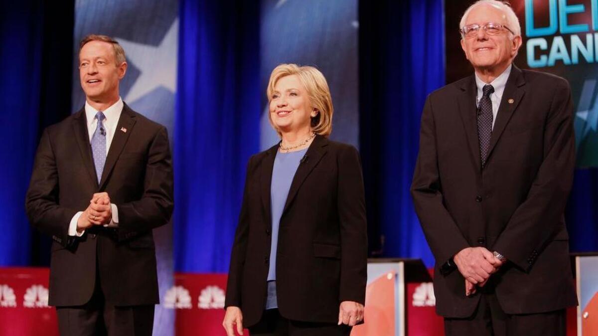 Democratic presidential candidate, former Maryland Gov. Martin O'Malley , left, Democratic presidential candidate, Hillary Clinton and Democratic presidential candidate, Sen. Bernie Sanders, I-Vt, stand together before the start of the NBC, YouTube Democratic presidential debate at the Gaillard Center, Sunday, Jan. 17, 2016, in Charleston, S.C.