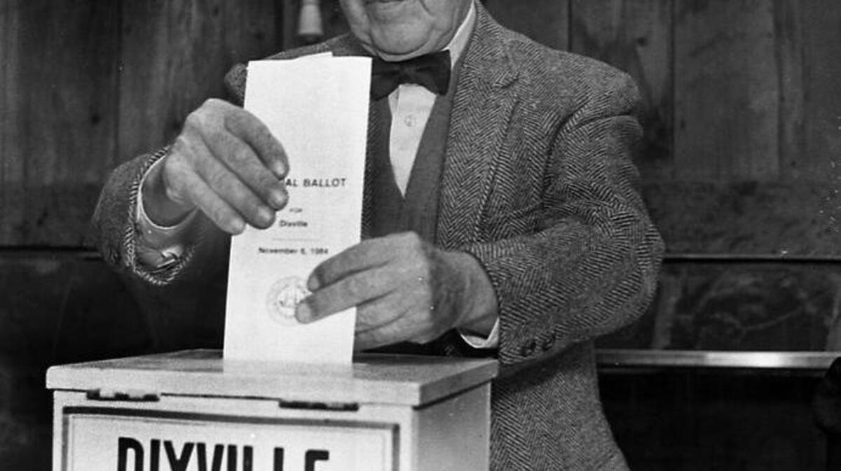 In this Feb. 28, 1984, file photo, Neil Tillotson gets ready to cast the first ballot in the New Hampshire presidential primary in Dixville, N.H. In Dixville, one of three tiny northern towns where voters will cast ballots just after midnight Feb. 9, no one quite knows how the early voting tradition started. But most agree it had something to do with rival photographers.