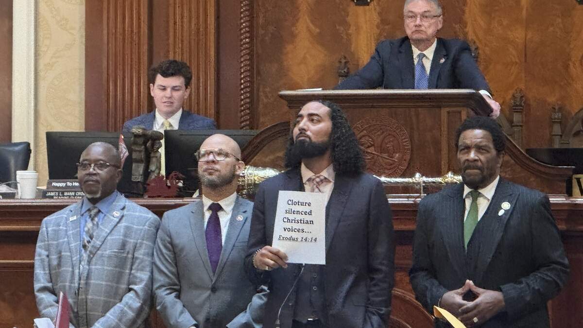 State Rep. Justin Bamberg, D-Bamberg, holds a sign that says “Cloture silenced Christian voices. Exodus 14:14,” on Wednesday, Feb. 25, 2026, as he protested how the SC House limited debate on a bill to require the 10 Commandments be posted in classrooms in the state.