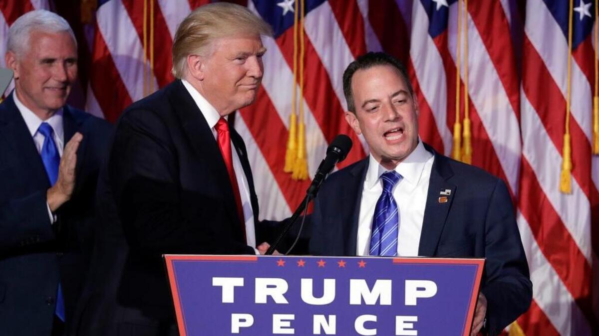Reince Priebus, Chair of the Republican National Committee, right, speaks as President-elect Donald Trump gives his acceptance speech during his election night rally, Wednesday, Nov. 9, 2016, in New York.