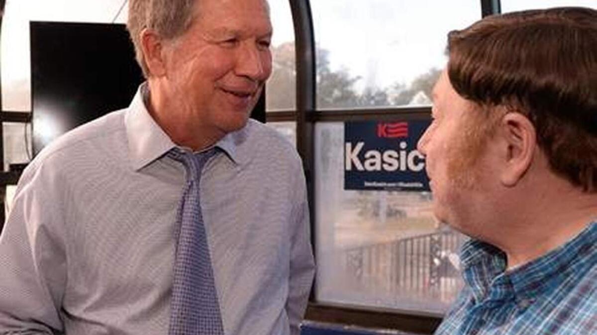 Republican presidential candidate John Kasich makes a campaign stop at the Beacon Drive-In in Spartanburg, Thursday, Nov. 19, 2015. Robert Willis, right, talks to Kasich following the town hall meeting.
